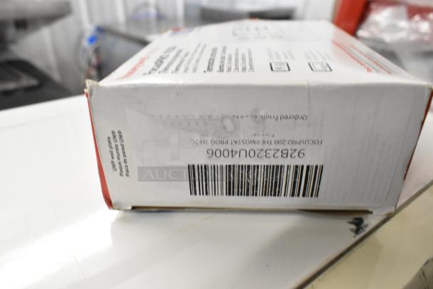 Box of FocusPRO 200 Thermostat and Wired Indoor Temperature Sensor, model 92B2320U4006. New condition, scratch and dent.
