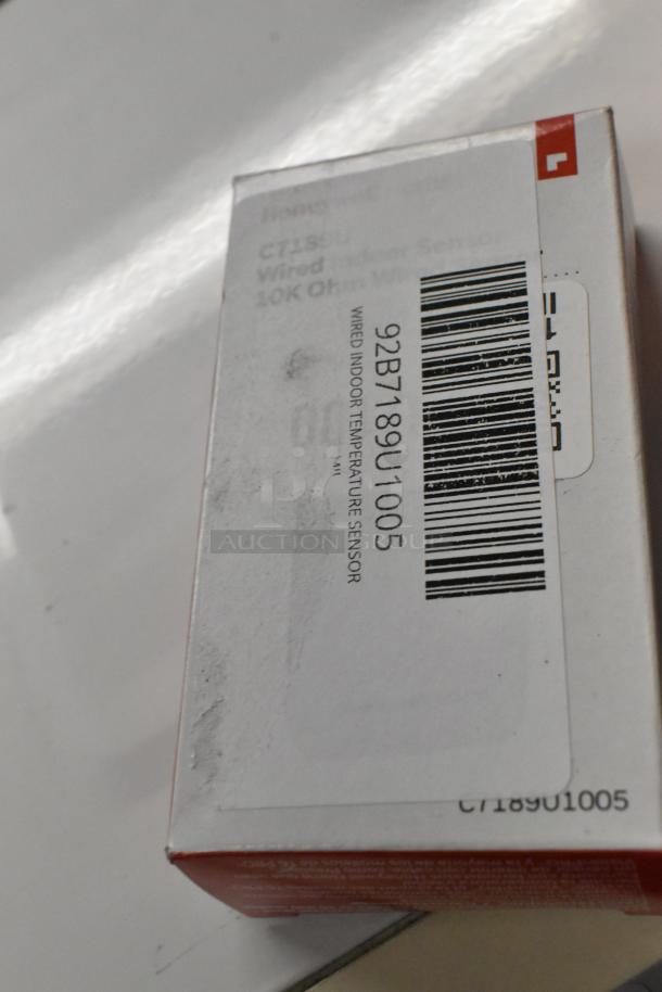 Wired indoor temperature sensor, model 92B7189U1005, in packaging. New, scratch and dent condition with visible barcode label.