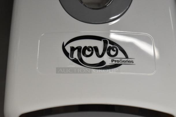 Novo ProSeries white manual foam dispenser, model 147NFMNDSPGY, scratch and dent condition, logo visible.