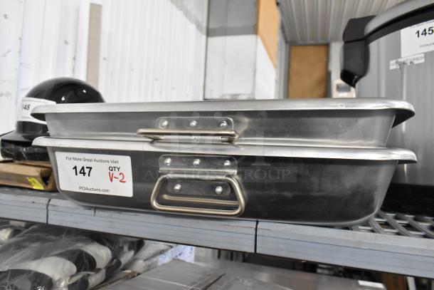 2 new Choice 471ALRP1826H aluminum roasting pans, 13 Qt each, with handles, 26" x 18" x 3.5", slight dents visible.