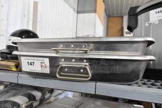 2 new Choice 471ALRP1826H aluminum roasting pans, 13 Qt each, with handles, 26" x 18" x 3.5", slight dents visible.