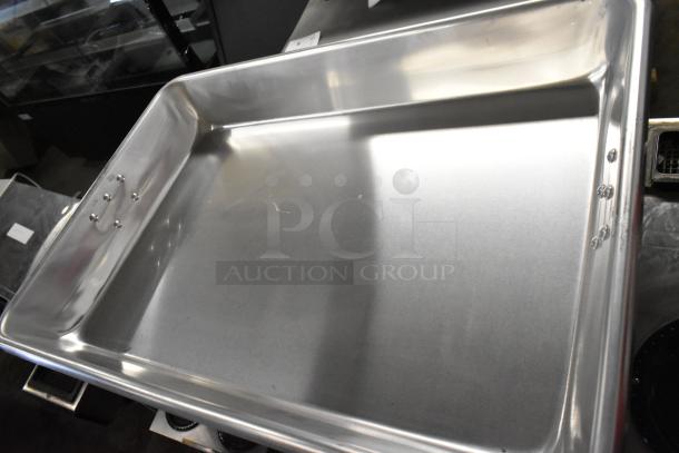 Brand new Choice 471ALRP1826H 13 Qt. aluminum roasting pan with handles, 26"x18"x3.5", minor scratches visible.