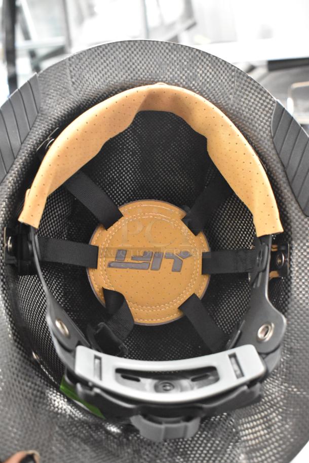 Helmet interior with padded liner and adjustable straps. Brand new condition, features reinforced carbon shell.