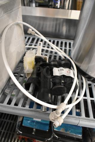 "7 brand new scratch and dent items including black legs and a white poly scooper on a metal shelf, labeled '150'."