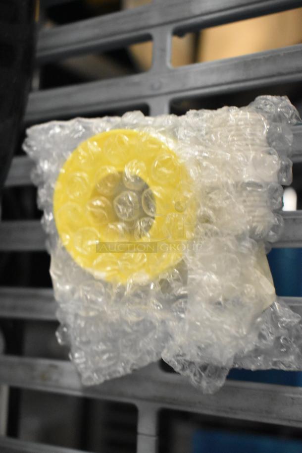 Bubble-wrapped yellow poly scooper, new scratch and dent item, offers seven times bid value.