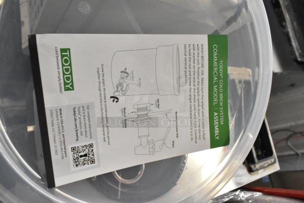 Brand new Toddy® 975CMLTCM 5 Gallon Commercial Cold Brew System with Lift. Features assembly instructions and label.