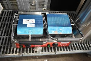 Brand new Avantco 177PG400T commercial dual panini grill with timer, grooved plates, 19 5/8" x 9 1/8" surface.