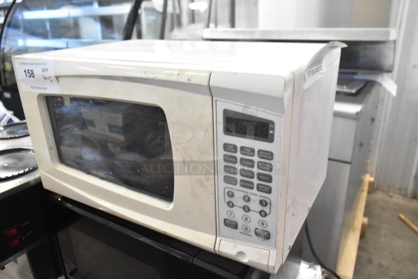Two countertop microwave ovens, models RGTM701 and MS8436127995-01, 120 volts, 1 phase, with plate, used condition.