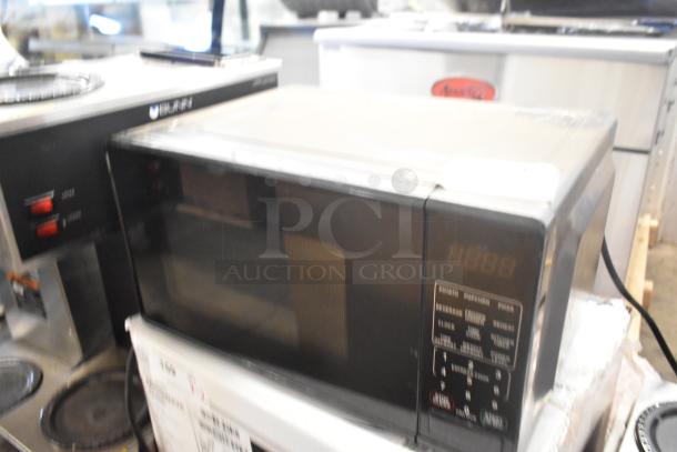 Two countertop microwave ovens with plates, models RGTM701 and MS8436127995-01, 120V, 1 phase, in good condition.