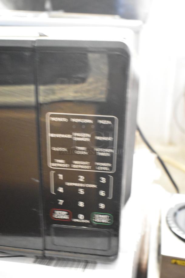 Two countertop microwave ovens with keypads. Models: RGTM701, MS8436127995-01. Includes plates, 120V, 1 phase.