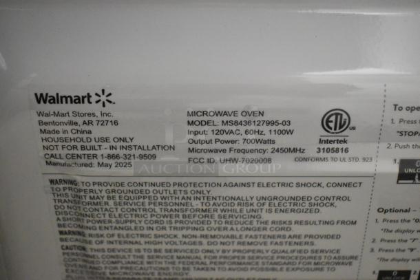 Label on microwave oven model MS8436127995-03, 120V, 60Hz, 1100W input, 700W output, made by Walmart, manufactured May 2025.