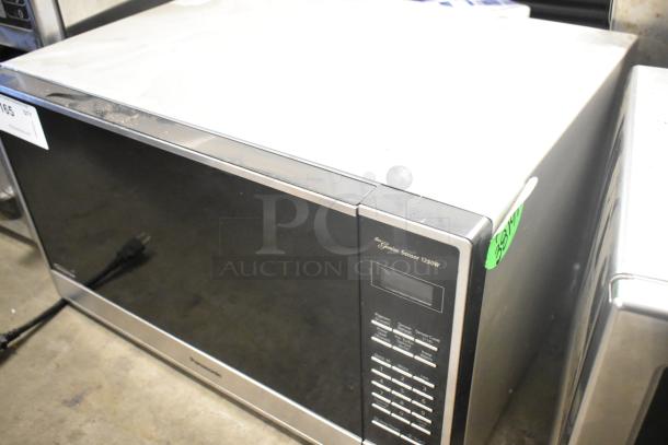 2023 Panasonic NN-SN975S stainless steel countertop microwave oven, 120 volts, 1 phase, visible control panel, minor surface marks.