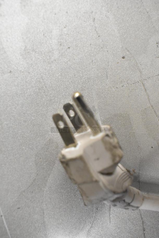 Close-up of a plug for the 2023 Panasonic NN-SN975S stainless steel countertop microwave, 120 volts, 1 phase.