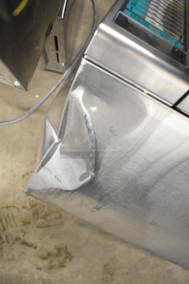 2024 Sharp R-21LVF stainless steel commercial microwave, dented side, 120 volts, 1 phase, countertop model.