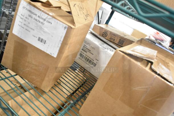 Boxes of miscellaneous items including Foresight Saliva Kit, Diversey Red Juice Stain Remover, Gojo Foam Handwash, slight scratches on packaging.