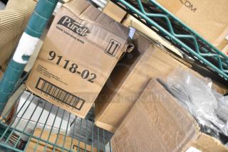 Cardboard boxes of new items including 9118-02 Purell Hand Sanitizing Wipes visible on a shelf. Scratched and dented.
