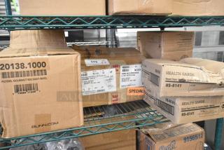 Boxes of new "scratch and dent" items on metal shelving. Includes Rubbermaid Auto Foam Refill and Health Gards Waxed Paper Liners.