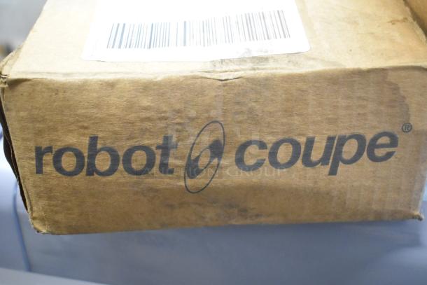 Cardboard box with "robot coupe" logo and barcode. Contains 11 items including metal fry basket, skimmer, and can liners.