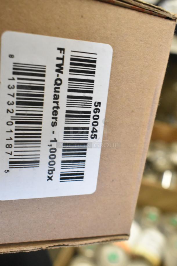 Cardboard box with a label "FTW-Quarters - 1,000/bx" and barcode, part of a lot with metal fry basket, skimmer, and can liners.