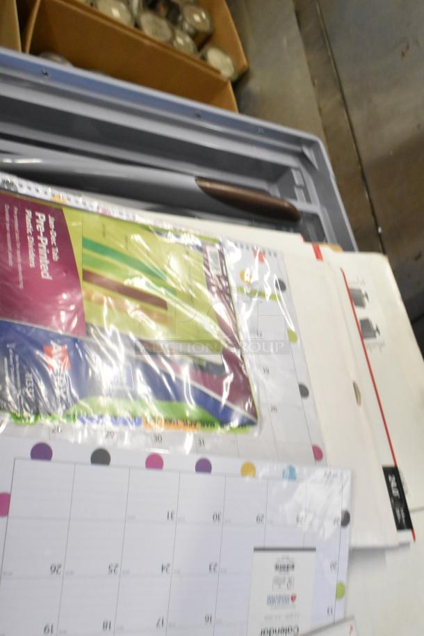 Assorted office items including a Kensington FP190W10 monitor privacy screen, pre-printed dividers, and calendar pages.