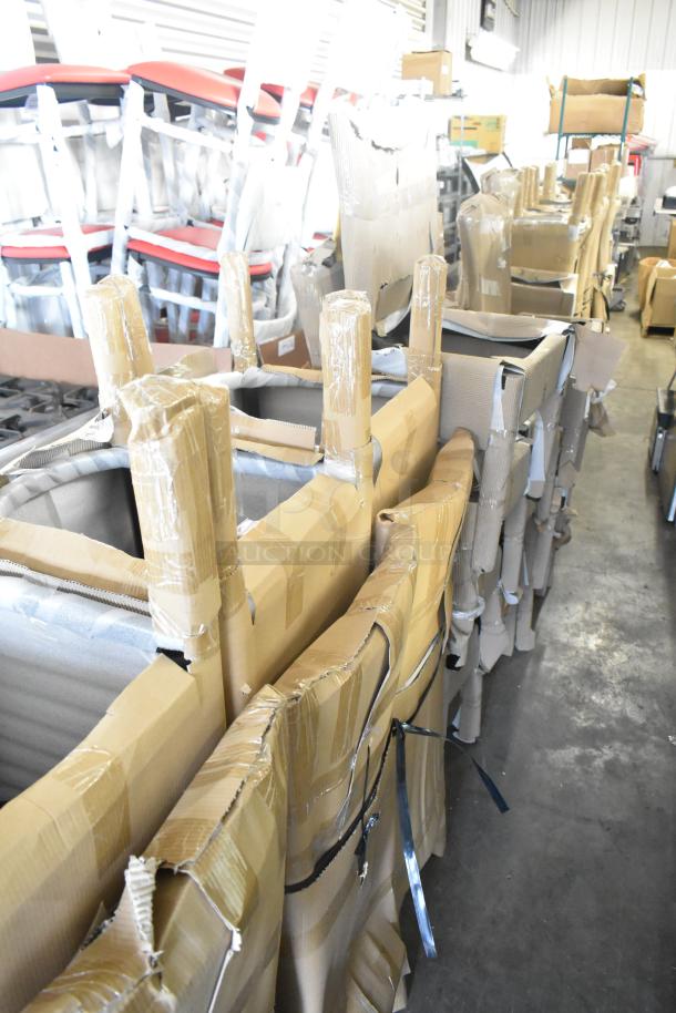 Stack of 40 brand new scratch and dent bar height chairs with black wood pattern and black seat cushions, wrapped for shipping.