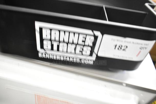 BRAND NEW SCRATCH AND DENT Banner Stakes black unit with branding visible, slight imperfections noted.