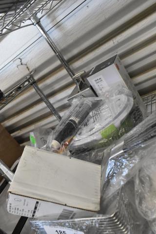 5 new scratch and dent items including Edlund electric can opener, SimpleHuman dispenser, ultimate bar tool. Various packaging visible.