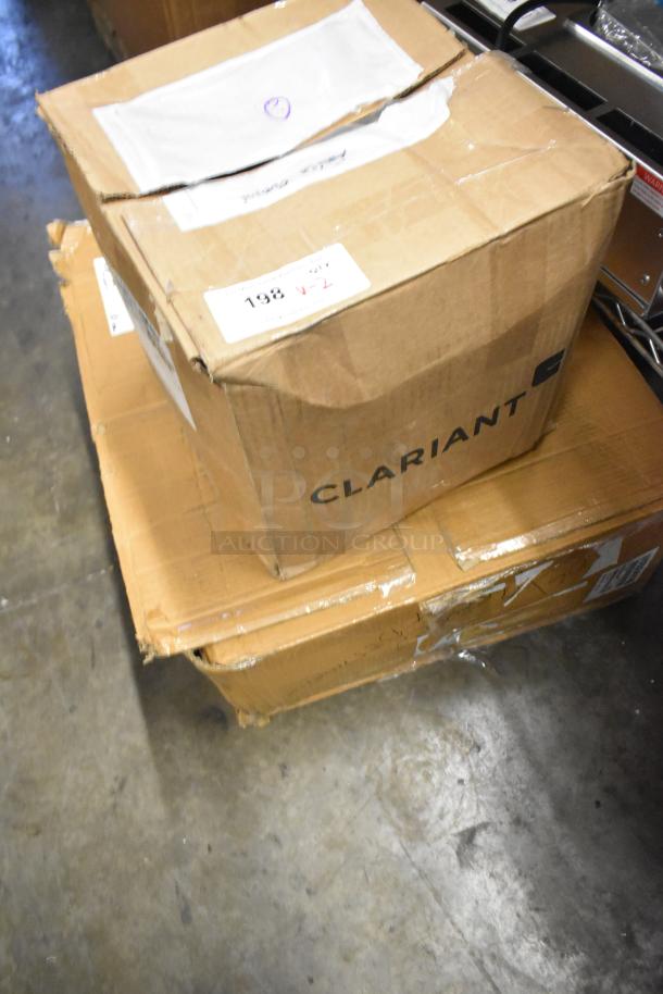 Boxes containing brand new Clariant container DRI packets and WS00849780 towels. Visible labels indicate 198 V-2.