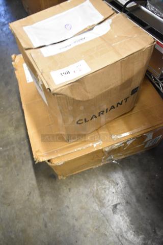 Boxes containing brand new Clariant container DRI packets and WS00849780 towels. Visible labels indicate 198 V-2.