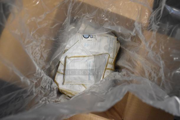 Auction item box with Clariant Container DRI packets, brand new condition, partially visible through clear plastic lining.