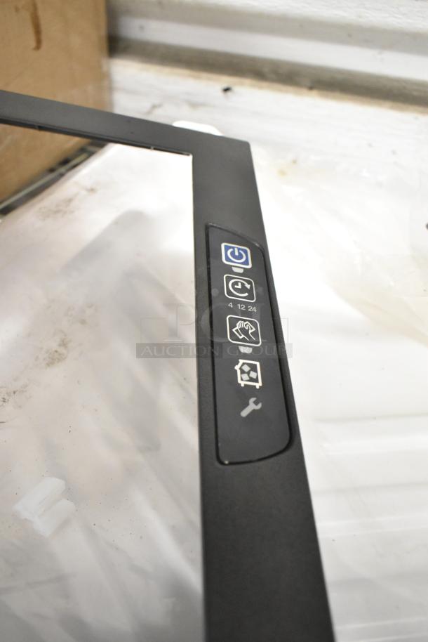 2 brand new Manitowoc Ice parts including 4010989 water curtain, visible control icons on black panel, scratch and dent condition.