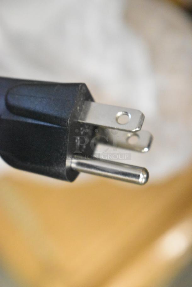 Close-up image of a power plug for the Avantco 177W62 heat lamp and food warmer, suitable for 120 Volts, 1 Phase.