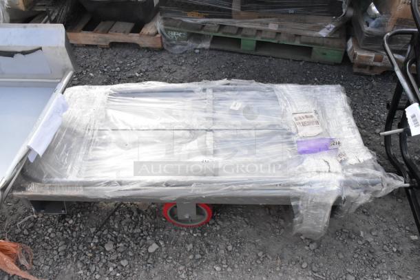 Brand new Lavex 24" x 48" steel U-boat cart, 2000 lb. capacity, wrapped in plastic, visible tags and labels.