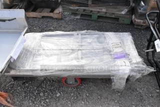Brand new Lavex 24" x 48" steel U-boat cart, 2000 lb. capacity, wrapped in plastic, visible tags and labels.