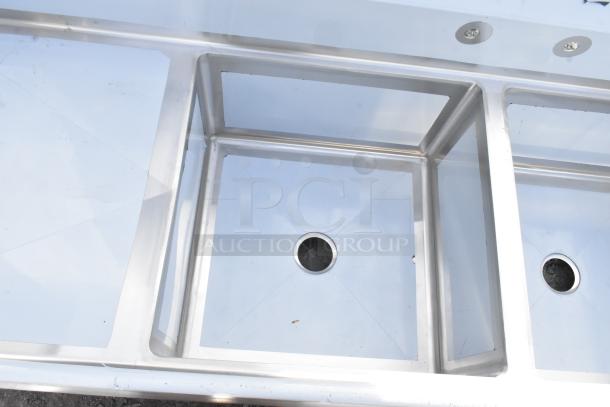 BRAND NEW Regency 600S42424224 stainless steel 4 bay sink with dual drain boards, no legs, minor scratches.