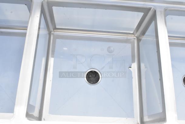 Brand new Regency 600S42424224 stainless steel 4 bay sink, dual drain boards, scratch and dent condition, no legs.