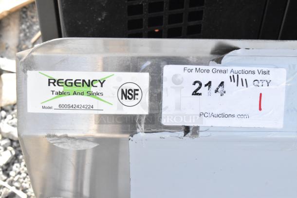 Regency 600S42424224 stainless steel 4-bay sink with dual drain boards, brand new with visible scratches. No legs. NSF certified.