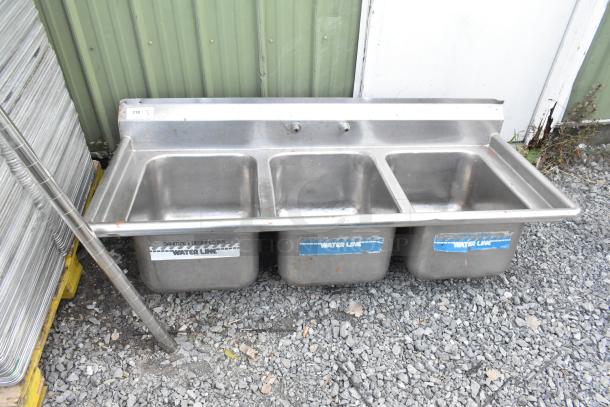 Stainless steel 3 bay sink, no legs, outdoor setting, with visible "Water Line" labels.