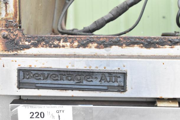Beverage Air stainless steel 2-door reach-in freezer, visible rust and wear, branded label shown.