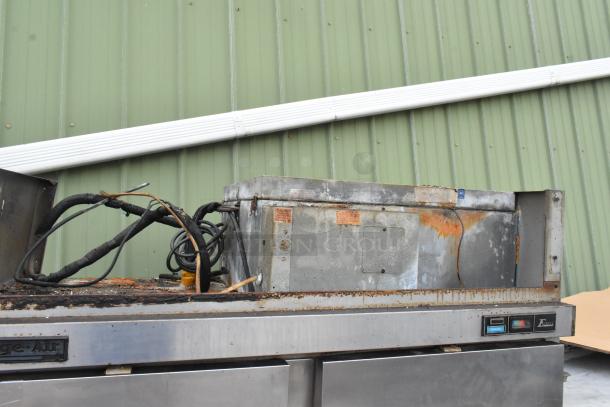 Beverage Air stainless steel commercial 2-door reach-in freezer, showing visible rust and wear on the top unit, with control panel and wiring exposed.