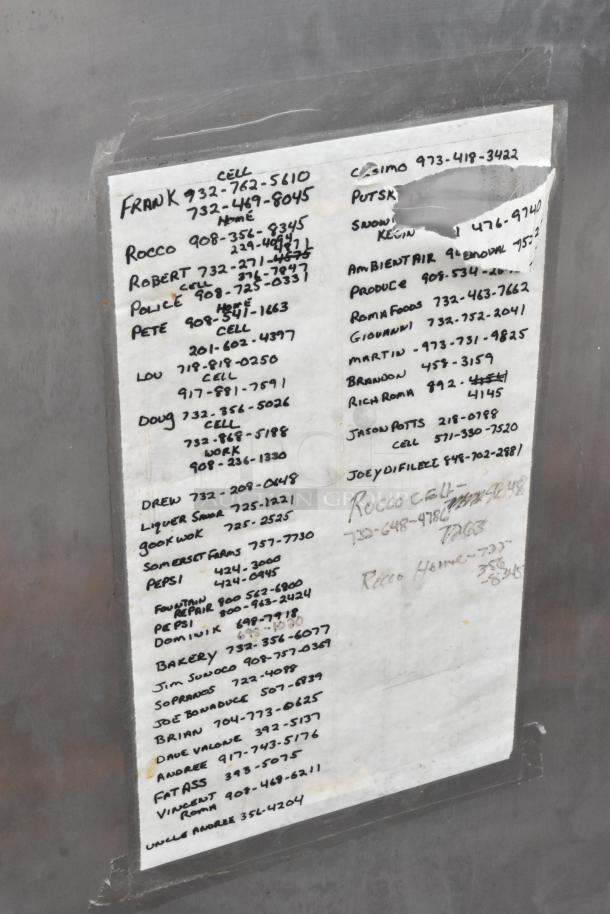 Beverage Air Stainless Steel Commercial 2 Door Reach In Freezer, with handwritten contact list taped to the surface.