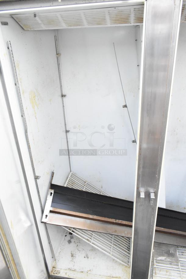 Beverage Air stainless steel 2-door freezer, reach-in style, visible wear, interior shelving included, commercial use.