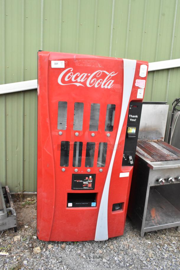 Royal Vendors RVCV2-660-8 vending machine, red with Coca-Cola branding. 115 volts, 1 phase, used condition, exterior scratches.