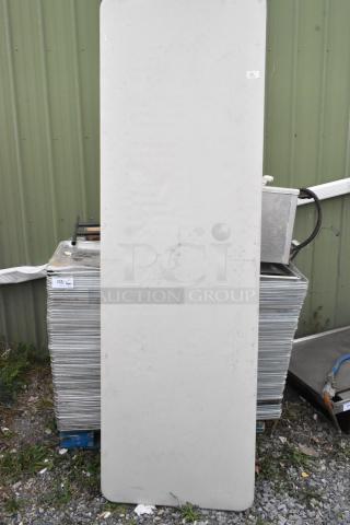 Stack of 400 metal full-size baking pans in used condition. Number tags indicate lot and bid multiplier.