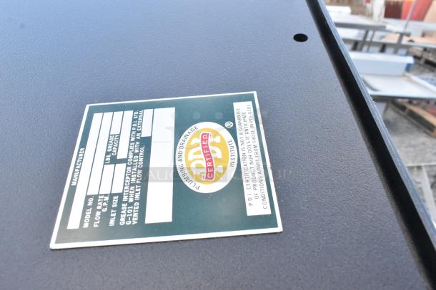 Label on Ashland PolyTrap 4850 grease trap showing certification, model, flow rate, and capacity details.