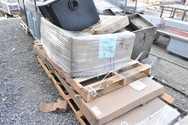 Palette of new scratch and dent items, including Regency door and work table, Ashland grease trap, all shrink-wrapped.