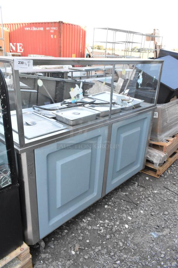 Metal buffet station with sneeze guard, featuring multiple trays, durable metal construction, in used condition.