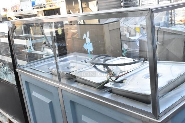 Metal buffet station with sneeze guard, includes multiple food pans, electrical cords, and whimsical decals. Good condition.