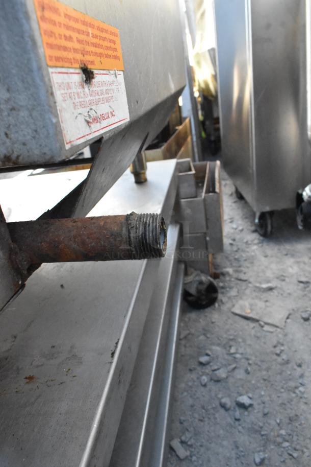 Rankin-Delux 24-C stainless steel griddle, natural gas powered, commercial use, visible wear on fitting, labels intact.