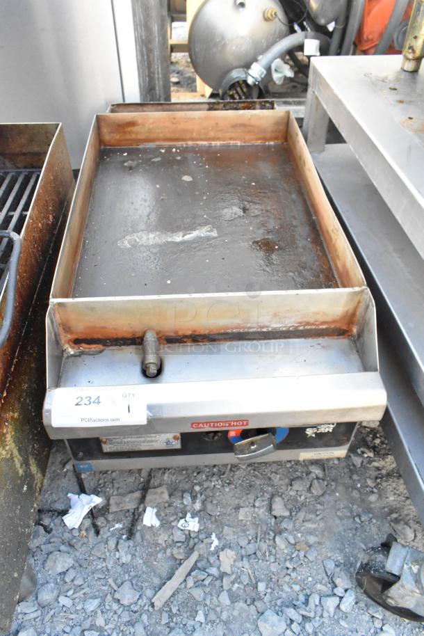 Star 613 stainless steel countertop gas griddle with flat top, showing visible signs of use and caution hot label.